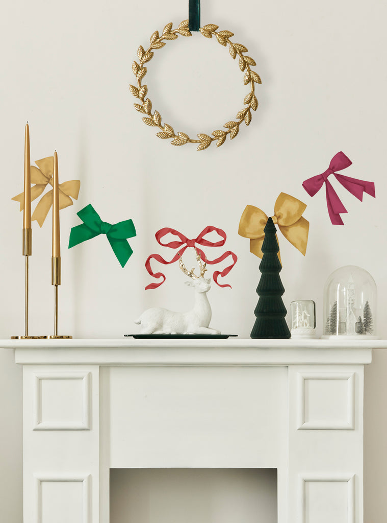 Festive holiday ribbons stickers in red, green, gold, and pink decorate a mantel with seasonal accents and warm atmosphere.