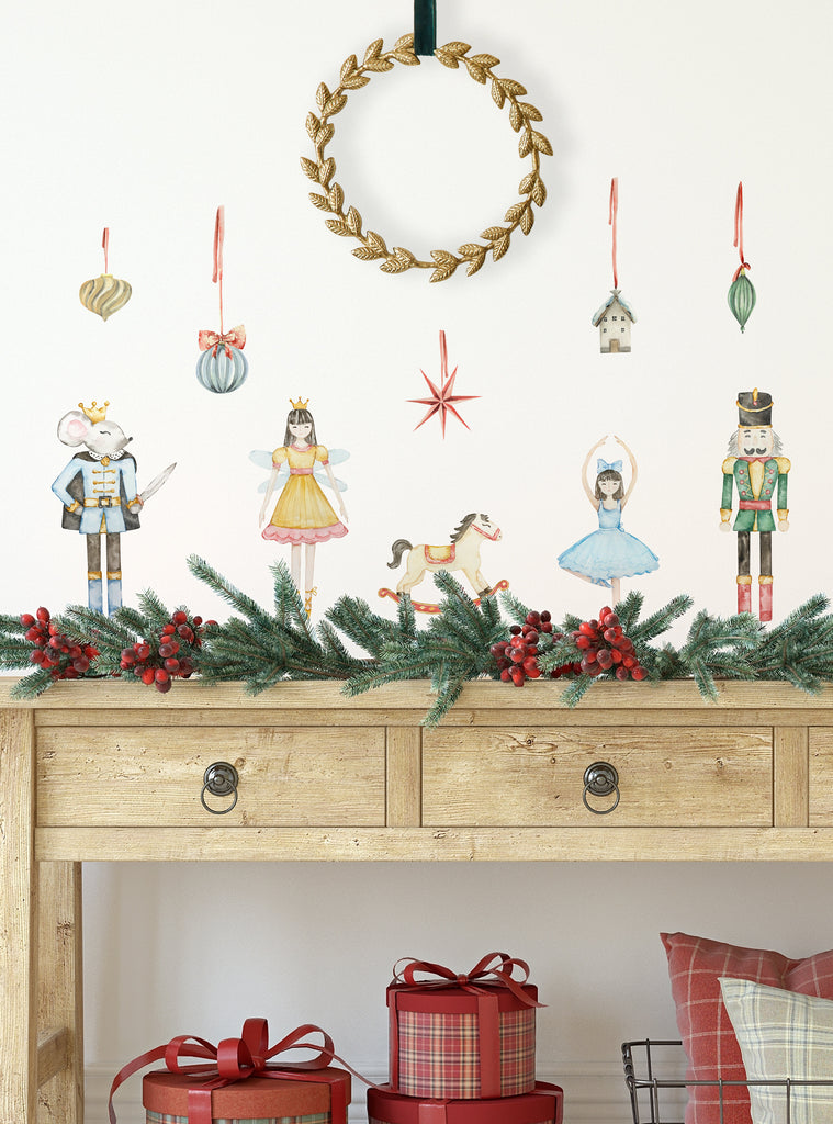 Nutcracker Ballet wall stickers featuring charming characters and festive ornaments above a wooden table with holiday greenery and gifts