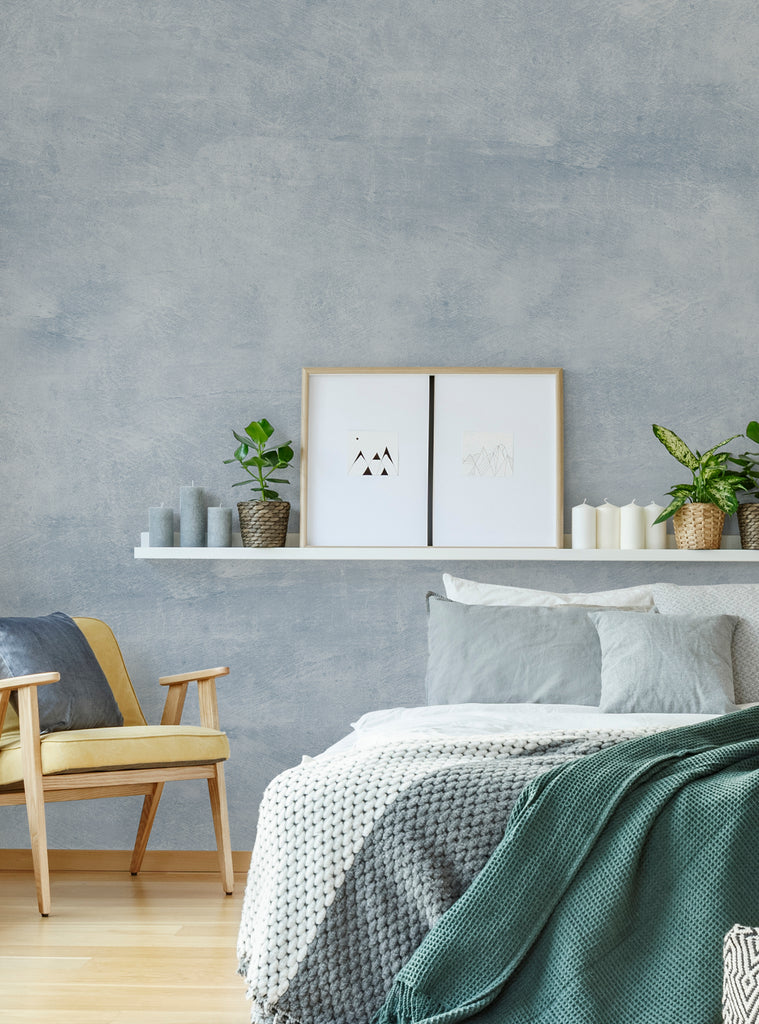 Modern bedroom featuring Venetian plaster faux texture mural wall art wallpaper in soft grey tones with cozy bedding and minimal decor