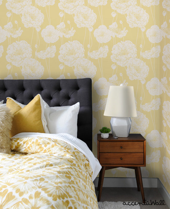 Bedroom corner featuring Peony Wallpaper in soft yellow with white floral prints, paired with a cozy bed and wooden nightstand.