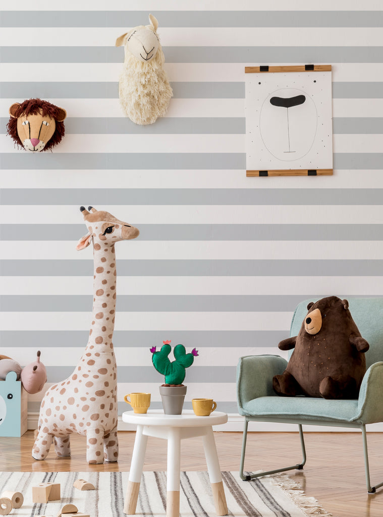 Cozy kids room with horizontal stripes wallpaper, plush animal toys, and soft pastel decor for a playful nursery space