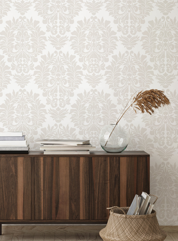 Elegant Damask Classic white peel and stick wallpaper displayed in a cozy living space with wood furniture and decorative accents