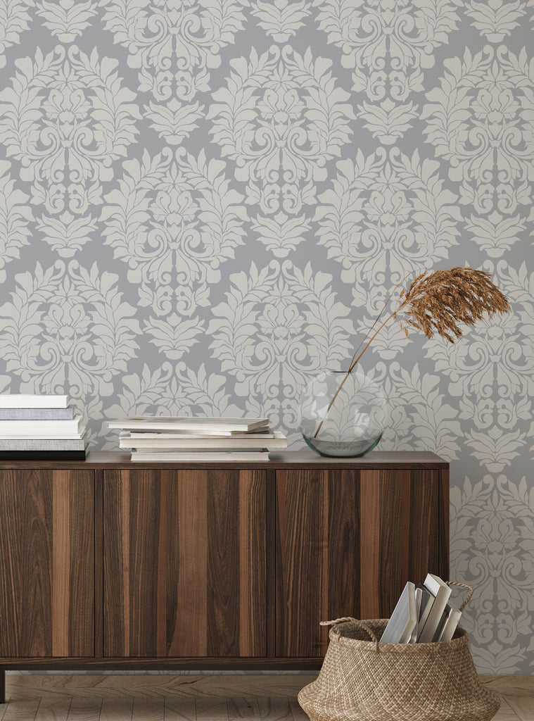 Gray and beige Damask Classic peel and stick wallpaper with elegant floral pattern above wooden console and woven basket