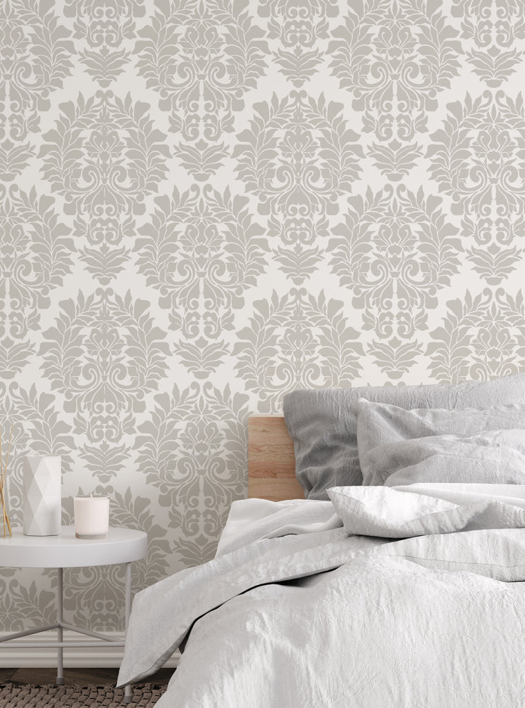 Elegant damask classic white peel and stick wallpaper with intricate detailing above a cozy bed in a modern bedroom setting