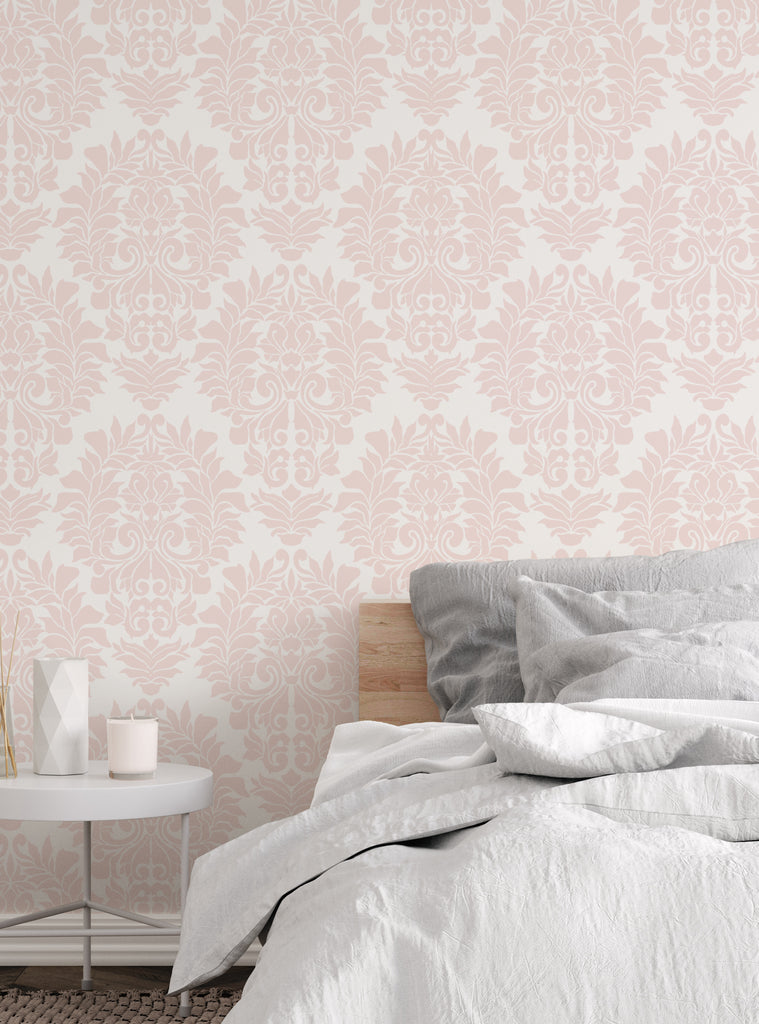 Peach and white damask classic peel and stick wallpaper in a cozy bedroom with soft gray and white bedding and a minimal side table.