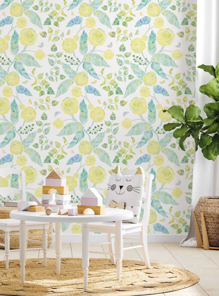 Bright yellow floral wallpaper with green leaves in a kids room featuring playful decor and pastel wooden toys on a round white table
