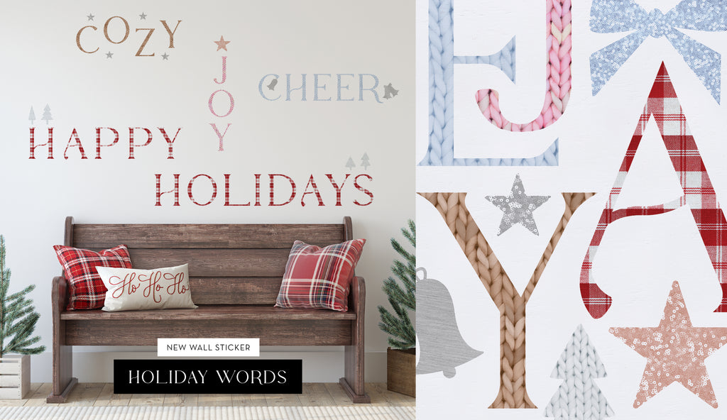 Cozy room with holiday-themed wall stickers spelling festive words above a wooden bench with red plaid pillows and greenery accents