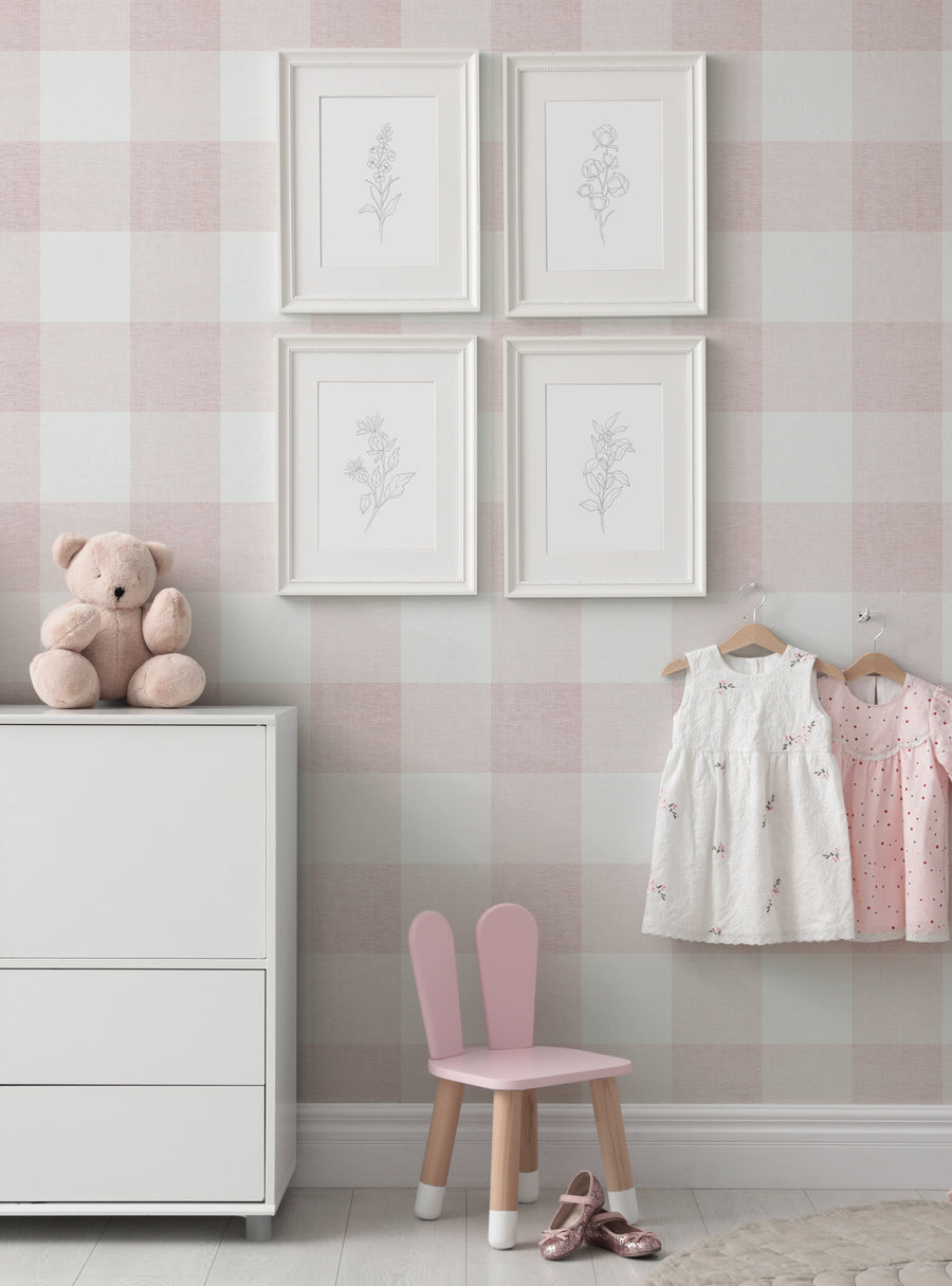 Elegant floral artwork in white frames on a soft pink and white checkered wall accentuates the cozy, country-style nursery decor. The image features a plush teddy bear, pastel-colored children's clothing, and a miniature pink chair, creating a charming and inviting atmosphere. , Featured Collection,Top Sellers,Peel and Stick Wallpaper,Nature Wallpaper,Surface & Texture Wallpaper,Geometric & Pattern Wallpaper,Kids and Baby Nursery Wallpaper,All Pr