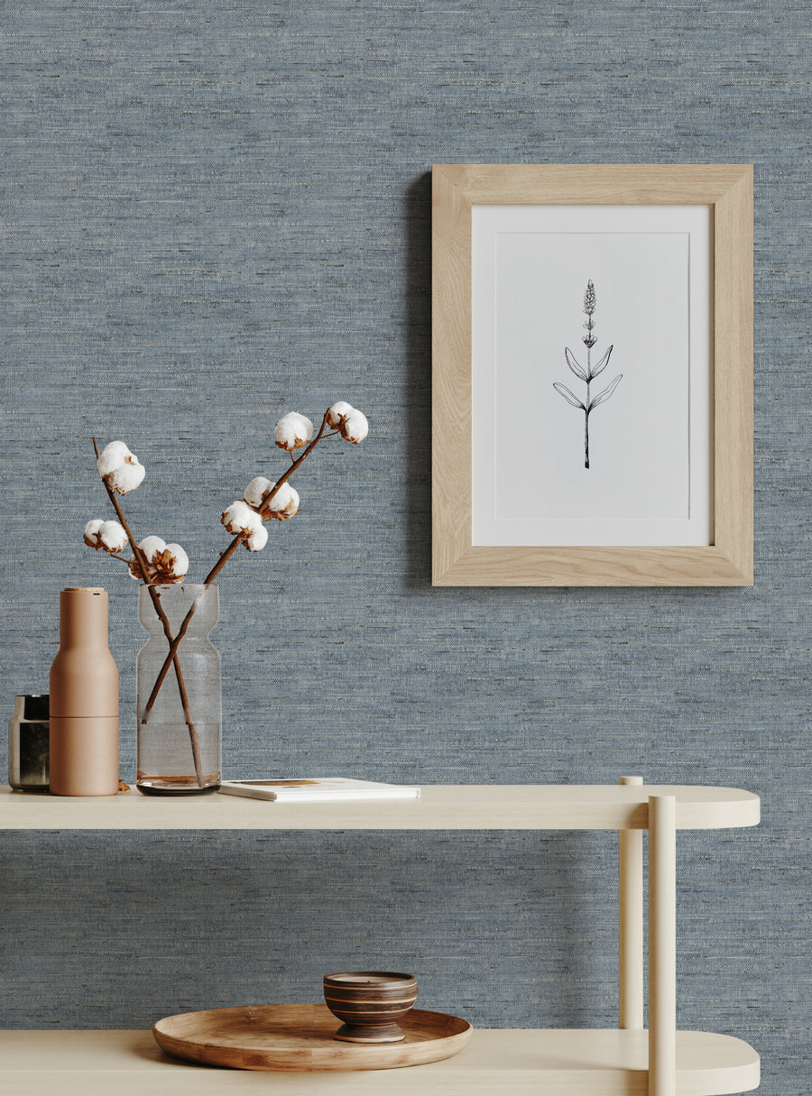 Cozy blue textured wallpaper from the Featured Collection with minimalist framed botanical art and natural decor accents.