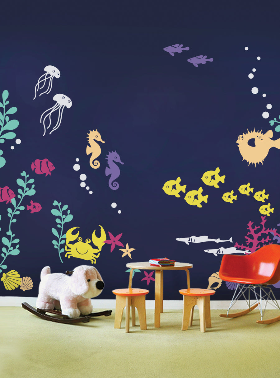 Vibrant sea creatures come alive in this whimsical under the sea wall decal set, perfect for transforming a baby nursery or kids' playroom into an enchanting underwater oasis. Featuring a variety of colorful fish, jellyfish, seahorses, and coral, this versatile decal collection allows you to create a personalized marine-themed display. With separate decal pieces, you can easily arrange the elements to suit your desired aesthetic. This product off