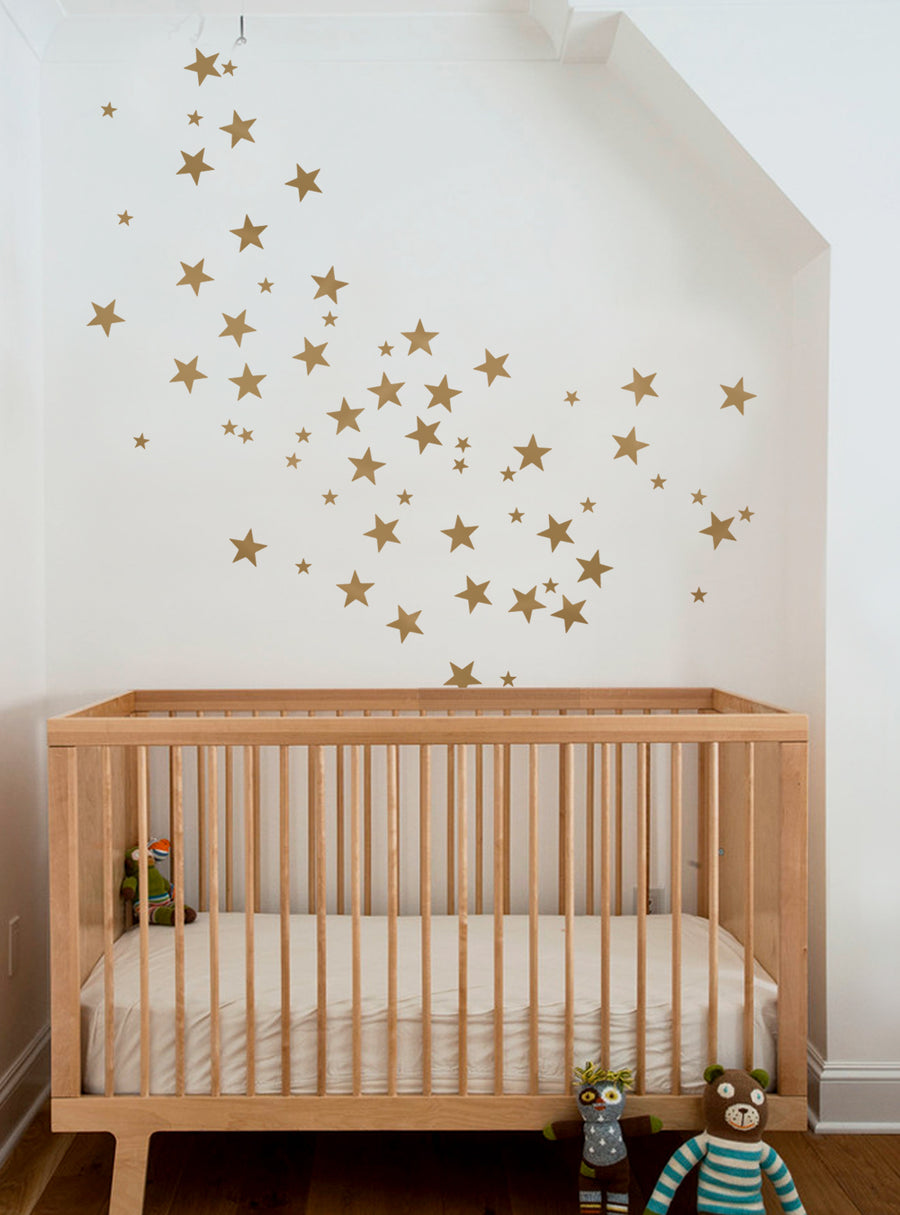 Sparkling golden stars decorate the nursery wall, adding a touch of whimsy and enchantment to the cozy space. These Small Stars Wall Decals are available in a variety of vibrant colors, making them a versatile choice for personalizing any child's bedroom or playroom. A charming and customizable accent for creating a magical, star-studded atmosphere., Top Sellers,Wall Decals,Baby Nursery and Kids Wall Decals,All Products