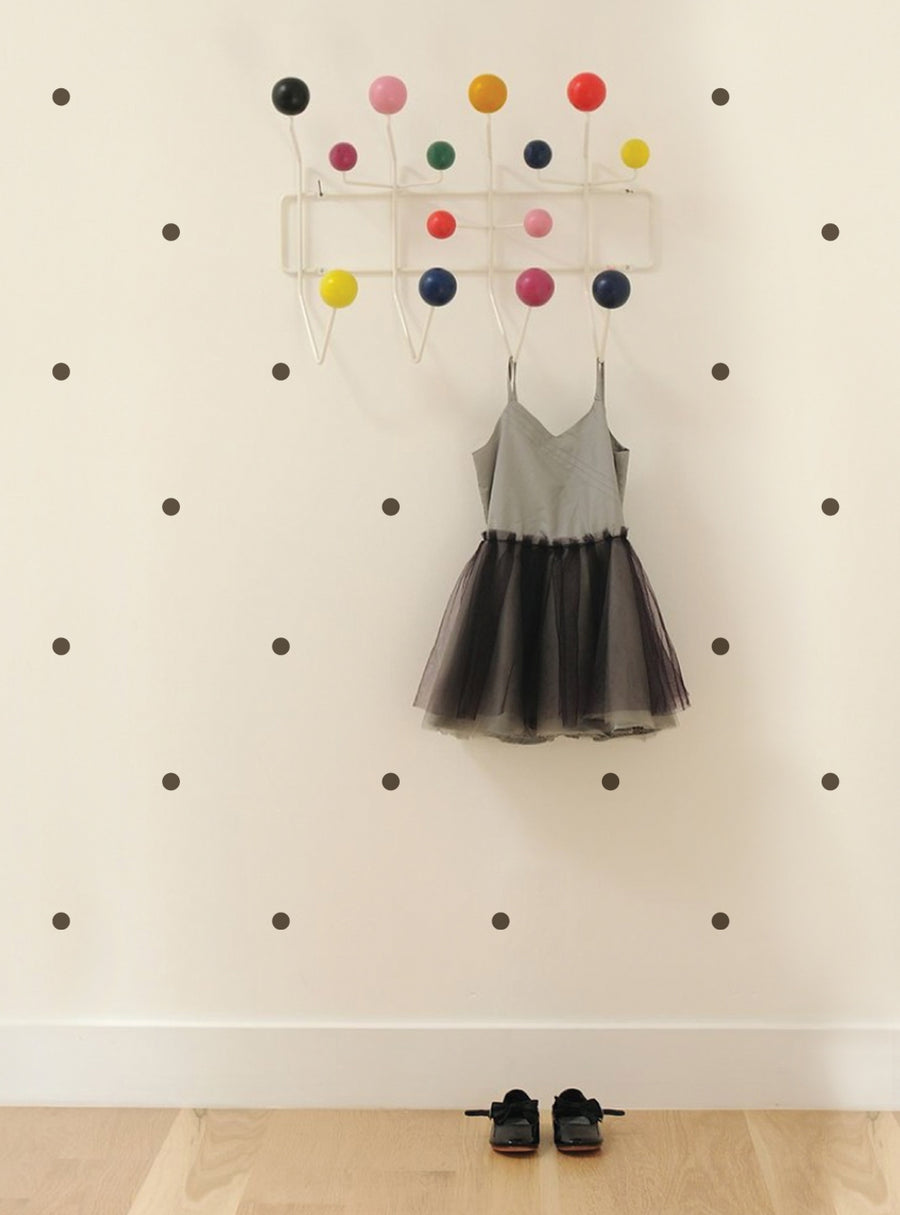 Colorful polka dot wall decals adorn the background, creating a fun and vibrant atmosphere. A stylish black tulle dress hangs from the wall, adding a touch of playfulness and whimsy to the scene. The decals and the dress work together to create a charming and inviting nursery or playroom setting. , Top Sellers, Wall Decals, Baby Nursery and Kids Wall Decals, All Products