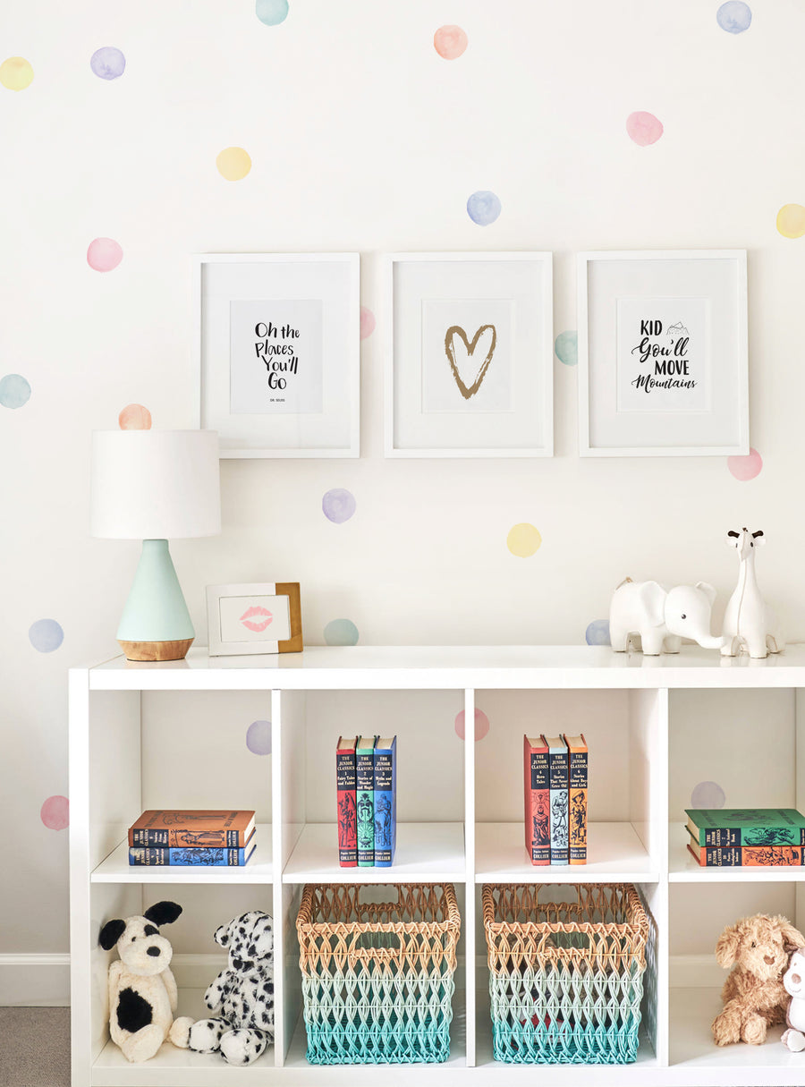 Whimsical pastel watercolor dots adorn this modern vintage-inspired nursery wall, creating a playful and charming ambiance. The dots add a touch of playfulness and charm to the space, complementing the framed artwork and decorative elements perfectly. This eye-catching wall decor is sure to be a statement piece and a top seller for any home or holiday decor lover seeking pattern wall stickers to customize their space.