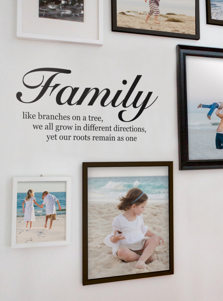A wall decal displaying an inspirational quote about family, with the text "Family like branches on a tree, we all grow in different directions, yet our roots remain as one", accompanied by framed photos of a family on the beach. This product is a complementary piece to a Family Tree Wall Decal, and is available in various color options. , Top Sellers, Wall Decals, Family Tree Decals, Lettering and Quote Decals, Tree Decals, All Products