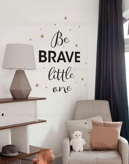 Inspirational wall art featuring the empowering quote "Be Brave Little One" with decorative gold stars, perfect for a nursery or child's bedroom. This eye-catching lettering wall decal can be customized with your choice of color for the quote and stars, adding a personalized touch to your space. Featured in our Collection of top-selling Wall Decals, Lettering and Quote Decals, Baby Nursery and Kids Wall Decals, and All Products.