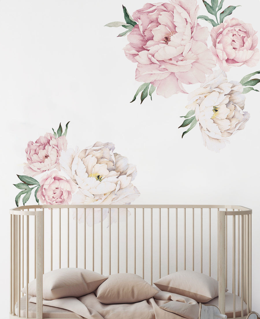 A serene nursery setting featuring a minimalist wooden crib with soft beige bedding. The wall is adorned with delicate watercolor floral decals showcasing pink and cream peonies, creating a gentle and inviting atmosphere. The overall design emphasizes a calming aesthetic, perfect for a child's room.