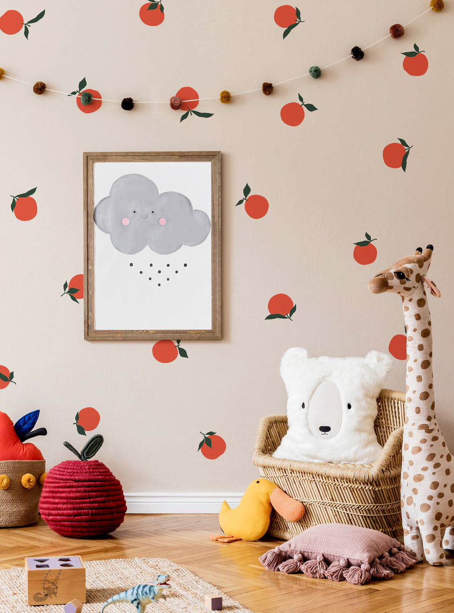 Vibrant orange fruits with green stems and leaves decorate the walls, creating a cheerful and playful atmosphere in this cozy nursery. The image showcases the versatility of the "Orange Fruit Wall Decal" product, which can be customized to suit various color schemes. , Top Sellers,Wall Decals,All Products