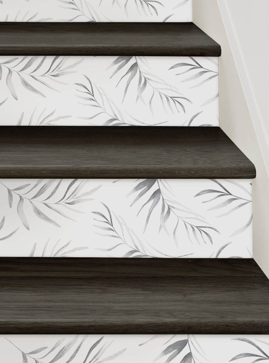 Tranquil palm leaves grace the stairs, creating a serene, nature-inspired atmosphere. This image showcases the Breezy Palm Leaves Peel and Stick Stair Riser Strips - a DIY decorative solution that adds a touch of tropical chic to any space. , Top Sellers,Stair Riser Decals,All Products,Nature and Floral Stair Riser Stickers