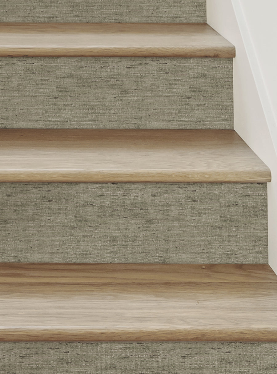 Wooden stair treads with a textured, canvas-like surface in a neutral, earthy tone, creating a unique and visually appealing design element for the space. These Canvas Look Peel and Stick Stair Riser Strips offer a versatile and easy-to-install solution for transforming ordinary stairs into a statement piece. , Top Sellers,Stair Riser Decals,All Products,Surface and Texture Look Stair Riser Stickers