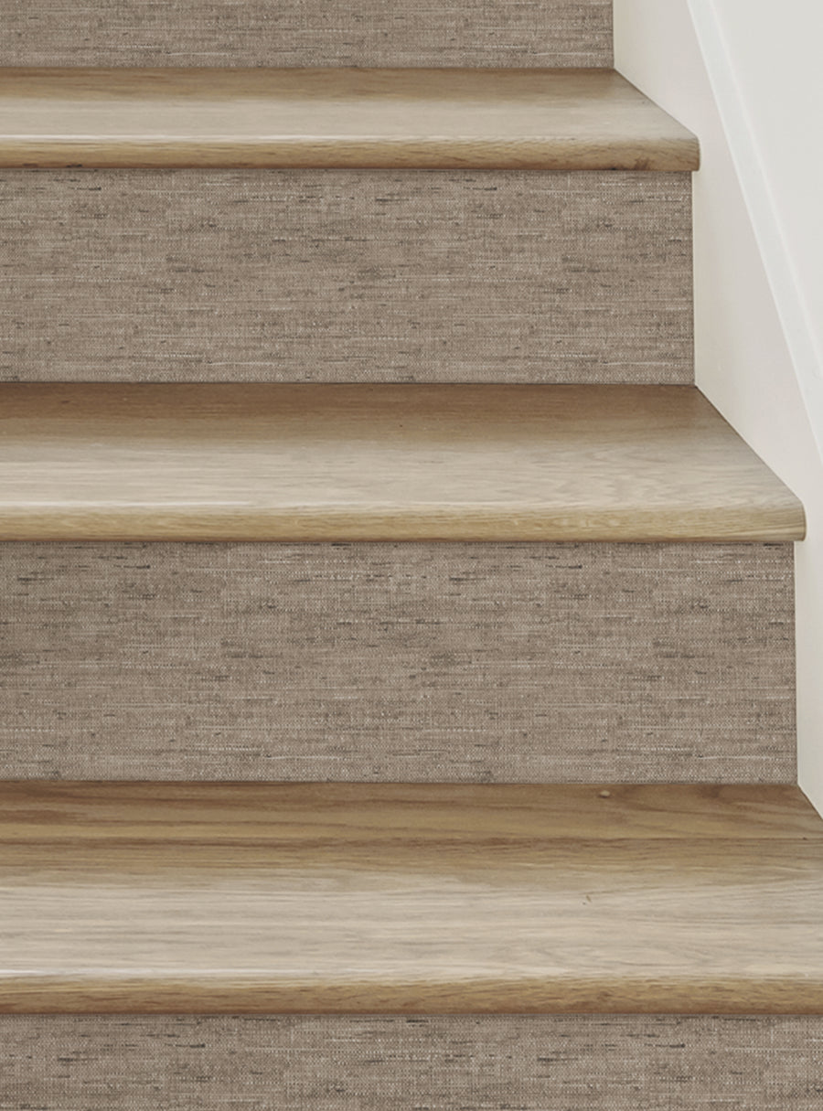 Wooden stairs with a canvas-like texture and color, showcasing the natural beauty of the wooden steps. These Canvas Look Peel and Stick Stair Riser Strips add a unique and comfortable feel to the space, making it a perfect DIY decorating solution. The stickers can be easily applied and removed without any stress or mess, providing flexibility for homeowners to customize their staircase. , Top Sellers,Stair Riser Decals,All Products,Surface and Te