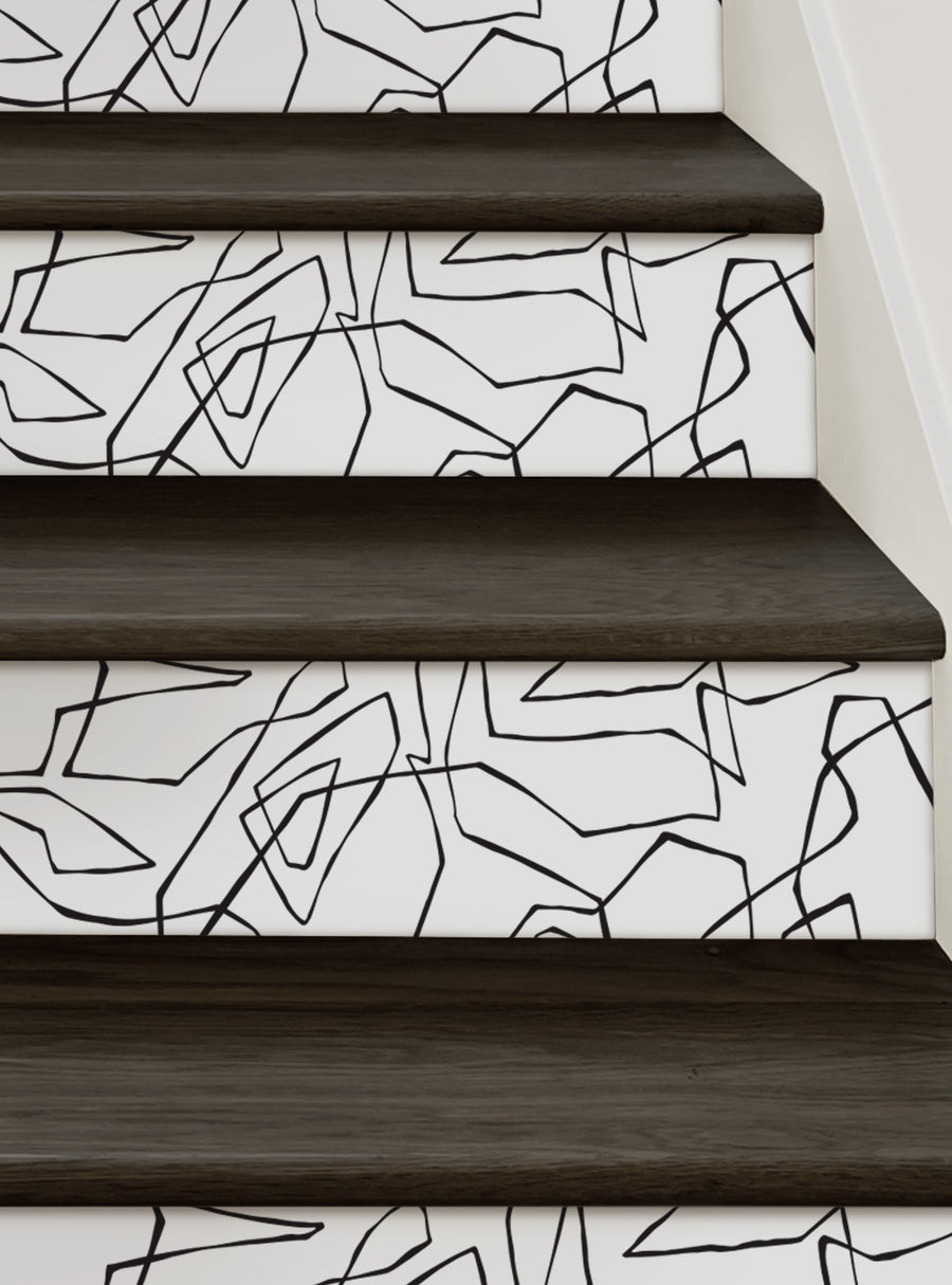 Captivating abstract geometric patterns adorn the stairs, creating a sleek and modern aesthetic. This Entangled Lines Abstract Peel and Stick Stair Riser Strips from Simple Shapes adds a touch of luxury and exotic flair to any space. Printed on premium adhesive backing for a mess-free and stress-free installation, this repositionable wall sticker is a versatile and stylish design solution. Top Sellers, Stair Riser Decals, All Products, Geometric 