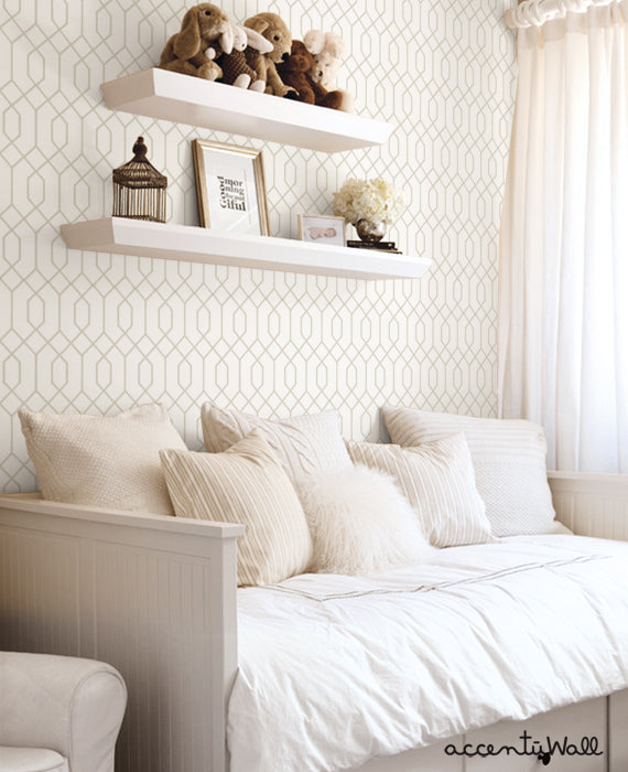 A cozy and inviting bedroom with geometric hexagon wallpaper, floating shelves displaying plush toys, and a serene white bed with decorative pillows. This image showcases a versatile, peel-and-stick wallpaper design that can be easily applied and repositioned for a stylish DIY room makeover. , Top Sellers,Peel and Stick Wallpaper,Geometric & Pattern Wallpaper,All Products,Unpasted Wallpaper,Wallpaper and Murals, W9190-Beige-Sample-Vinyl, W9190-Beige-Sample-Fabric, W9190-Beige-Sample-Unpasted