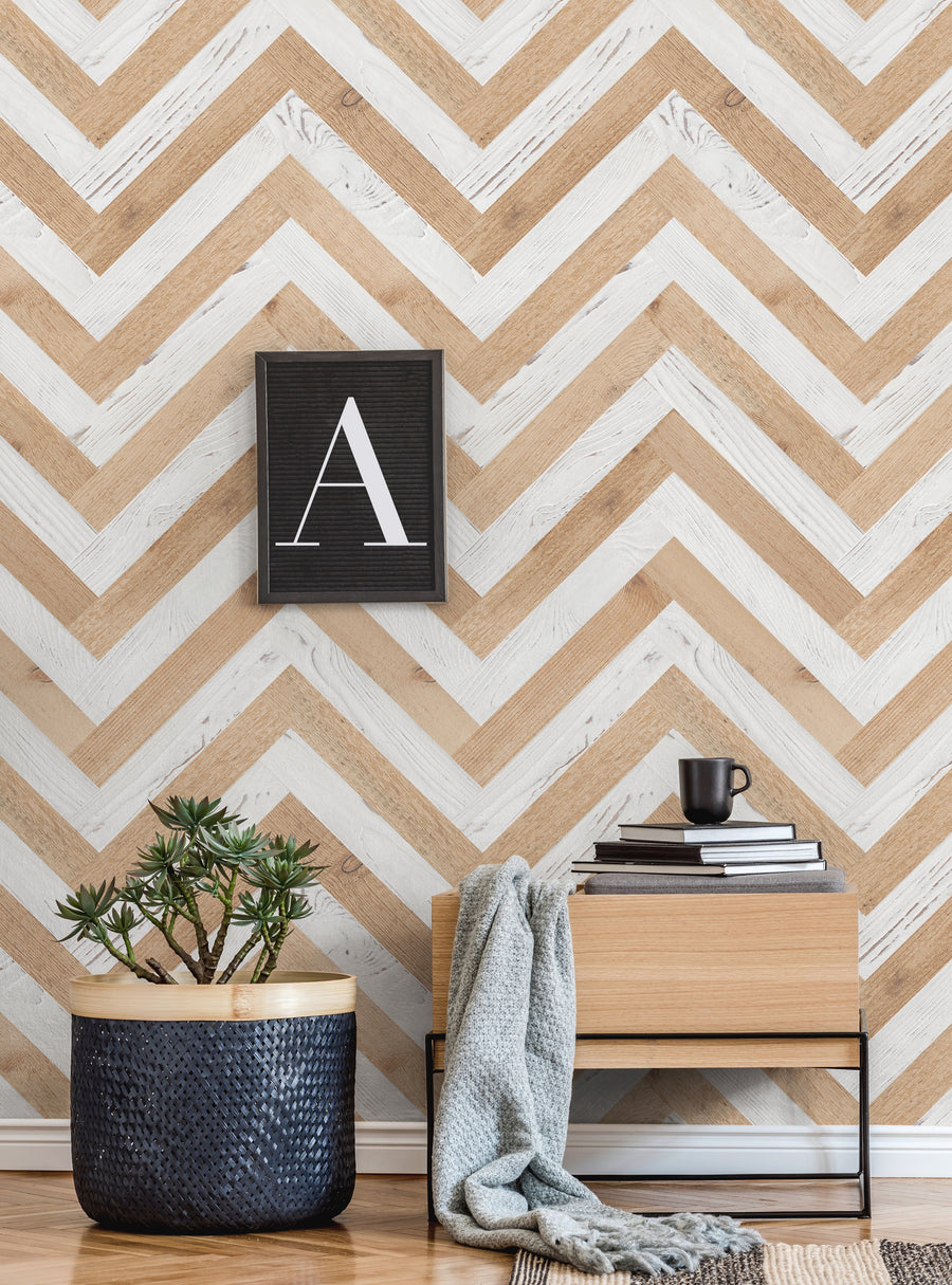 Chevron Striped Wood Peel and Stick Wallpaper - The image showcases a chevron-patterned wallpaper in natural wood tones, with a black framed letter "A" accent, potted plants, and a cozy, minimalist room setting. This repositionable, adhesive-backed wallpaper is easy to apply and remove, making it ideal for DIY home decor projects. , Top Sellers,Peel and Stick Wallpaper,Surface & Texture Wallpaper,Geometric & Pattern Wallpaper,Kids and Baby Nurser