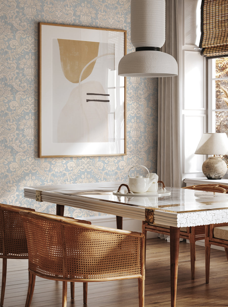 Textured damask patterned wallpaper adds an elegant touch to this modern dining space, complemented by a glass-topped table and wicker chairs. The abstract artwork in a gold frame adds a focal point, while the light fixtures and window treatments create a warm, inviting ambiance. This versatile wallpaper can be used in various rooms to elevate the style, from Top Sellers,Peel and Stick Wallpaper,Kids and Baby Nursery Wallpaper,All Products,Unpast